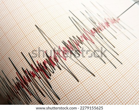      Seismograph and earthquake. A seismograph that records the seismic activity of an earthquake.                           Royalty-Free Stock Photo #2279155625