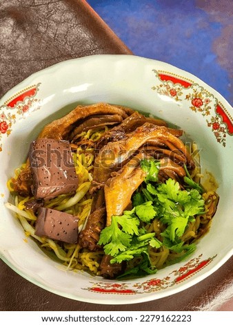 Dried egg noodle Stewed duck feet with noodles soup in bowl, Thai-Chinese food. 