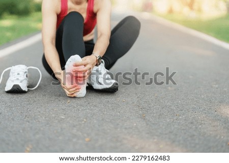 Young adult female with his muscle pain during running. runner woman having leg ache due to Plantar fasciitis. Sports injuries and medical concept Royalty-Free Stock Photo #2279162483