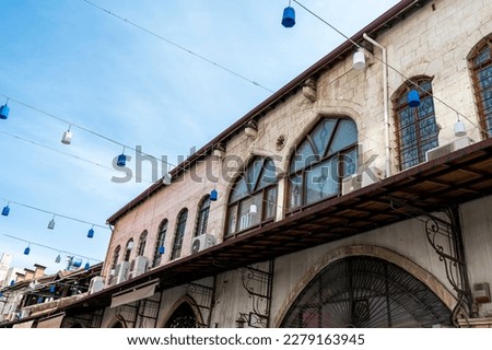 Traditional Antakya building in the old town with blue and white lights suspended on cables in the street before the earthquake of 2023. Bottom photo shoot.	