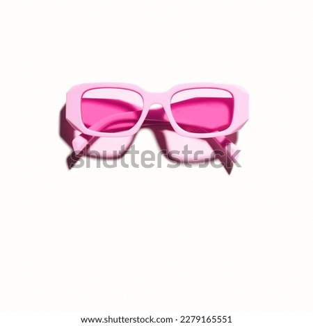 Stylish magenta sunglasses with transparent yellow glass isolated on white background, shadow from sunlight, summer fashion plastic-framed glasses. Summer sale concept. Top view eyeglasses photo Royalty-Free Stock Photo #2279165551