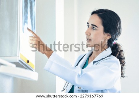 Doctor woman checking x-ray film in medical laboratory at hospital. 