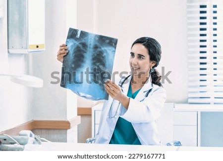 Doctor woman checking x-ray film in medical laboratory at hospital.