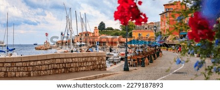 Seaside promenade with colorful restaurants along the Mediterranean Sea in Villefranche sur Mer Old Town on the French Riviera, South of France Royalty-Free Stock Photo #2279187893