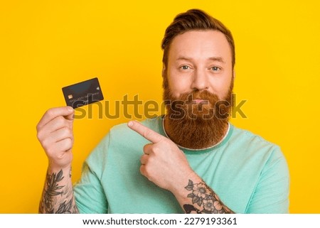Photo of successful man wear trendy clothes recommend use debit card transfer transaction isolated on yellow color background