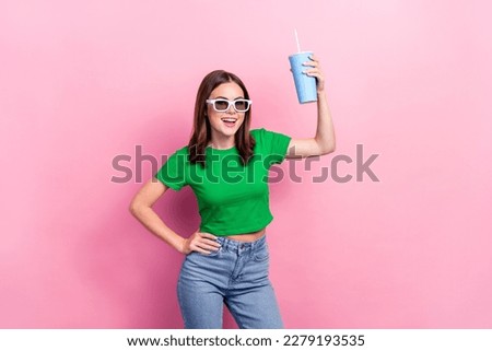 Photo of carefree cheerful girl have good mood arm hold soda drink isolated on pink color background