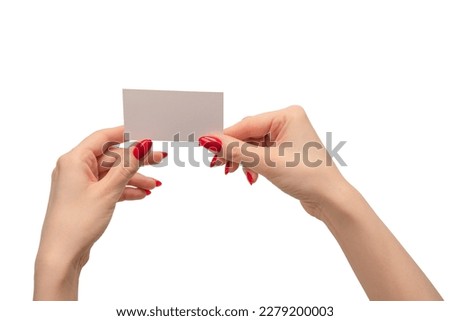 Empty card in woman hand with red nails  isolated on a white background. Copy space. 