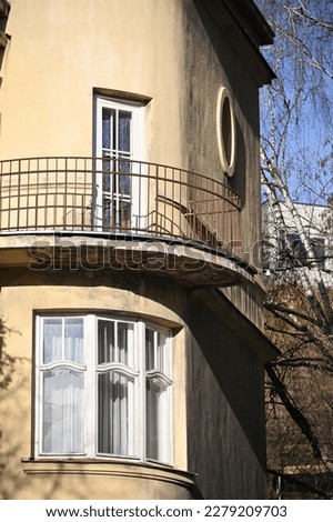 a rounded corner of a historic building with a balcony