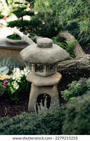 Stone garden lantern surrounded by vegetation