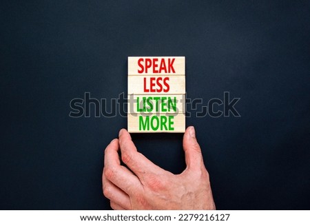 Speak less listen more symbol. Concept words Speak less listen more on wooden block. Beautiful black table black background. Motivational business speak less listen more concept. Copy space.