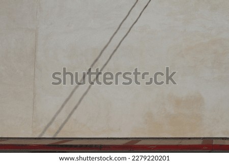Two shadowy lines on a blank wall. Two shadow lines.
