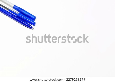 Ballpoint pens. Choice of handles. Colored pens. Ink pens for writing. The pens are on the page of the notebook. Stationery concept.