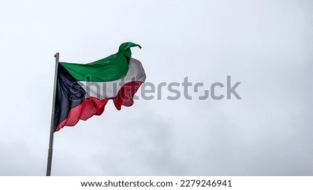 Kuwait national flag waving in kuwait sky. Royalty-Free Stock Photo #2279246941