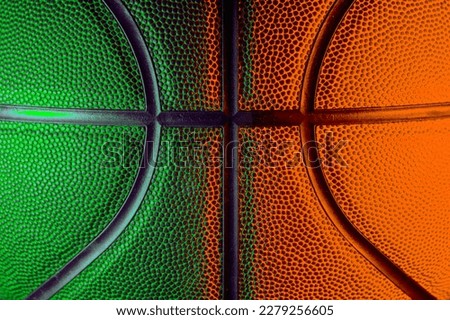 Closeup detail of basketball ball texture background. Green and orange neon. Banner Art concept