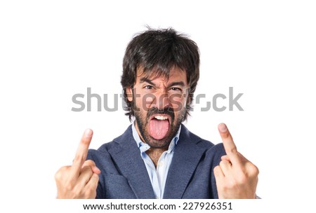Man making horn gesture over white background