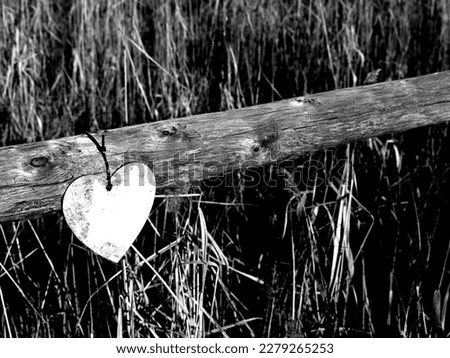 wooden heart hanging on the fence