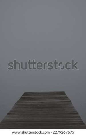 calm lake covered in fog