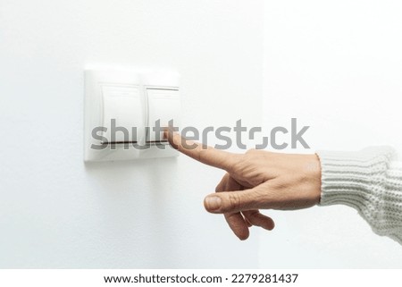 Activating Power: Woman Pressing an Energy Switch Royalty-Free Stock Photo #2279281437