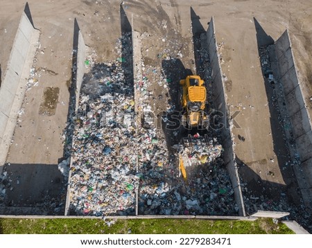Landfill site, a pile of stinky different junk disposal in the concrete section for unsorted waste materials Royalty-Free Stock Photo #2279283471