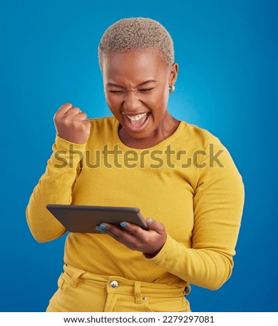 Success winner woman on tablet isolated on blue background fist pump, yes and cheers for online news. Winning, competition and giveaway prize for african person on digital tech celebration in studio Royalty-Free Stock Photo #2279297081