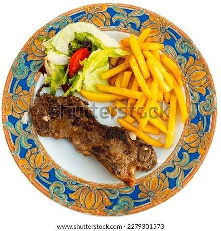 narrow slice of toasted entrecote is garnished with French fries and vegetables. Isolated over white background Royalty-Free Stock Photo #2279301573