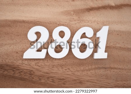 White number 2861 on a brown and light brown wooden background.