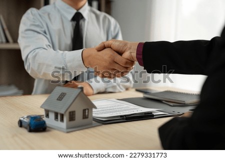 Home dealers, home and auto insurance agents shaking hands with businessman or investor agreeing to buy, sell or rent in ownership agreement signed on desk.