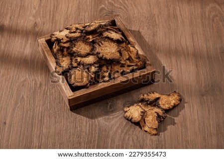 A square tray containing Szechuan Lovage Rhizome. Szechuan Lovage Rhizome (Ligusticum striatum) is used for kidney damage in people with diabetes, indigestion, kidney stones and other conditions Royalty-Free Stock Photo #2279355473