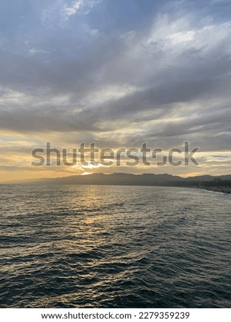 Ocean picture at sunset with clouds