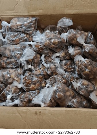 a group of Dates wrapped in transparent plastic, to be distributed to those who break their fast at the mosque. 