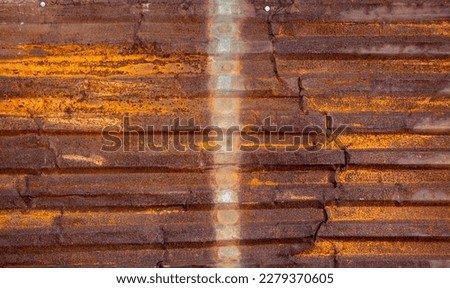 Background texture of a rusty metal barn plate.