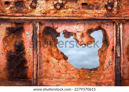 Background texture of a rusty metal barn plate.