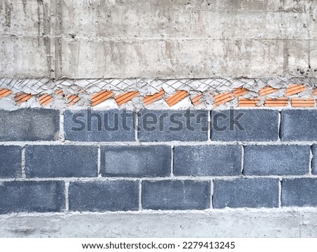 The brick blocks used to build the wall have not been plastered with cement.