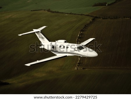 Cessna Citation in flight, business jet, private jet, or bizjet is a jet aircraft designed for transporting small groups of people. Business jets may be adapted for other roles, such as the evacuation Royalty-Free Stock Photo #2279429725
