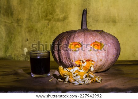 Haunted carved pumpkins for Halloween with liqueur