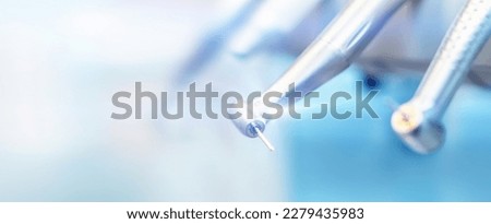 Closeup photo of dental handpieces and equipment on dental chair with blured background Royalty-Free Stock Photo #2279435983