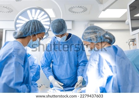 Doctor and assistant nurse operating for help patient from dangerous emergency case .Surgical instruments on the sterile table in the emergency operation room in the hospital.Health care and Medical