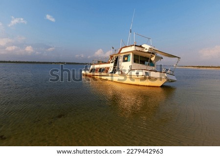 An abandoned  Power Catamaran boat, run aground, in Big Lagoon Pensacola, Florida. Royalty-Free Stock Photo #2279442963