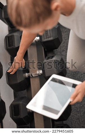 Fitness, woman and tablet mockup for weightlifting tutorial, exercise or schedule workout and planning at the gym. Hands of active female with touchscreen display for online training with dumbbells