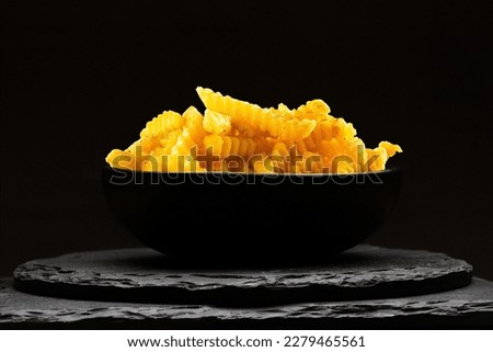 portion of potato crinkle on black stone background. French fries. Royalty-Free Stock Photo #2279465561