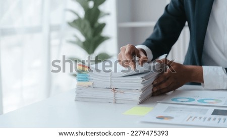 Paper stack, unfinished document, Close up hands of asian bookkeeper female working with stack of papers and balance sheet with bureaucracy hardworking in office desk.