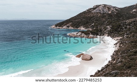 Aerial picture of little beach in two peoples bay reserve. Located in Albany, south west Australia. Amazing blue water, sand, rocks and mountains. Cliffs next to the beach. Two big rocks in the middle
