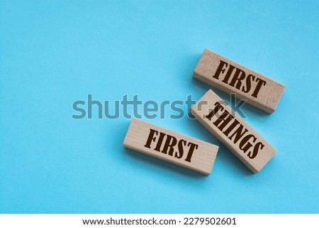 First Things First - words from wooden blocks with letters, Business concept	