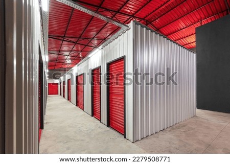 Corridor of self storage unit with red doors. Rental Storage Units Royalty-Free Stock Photo #2279508771