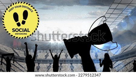 Composition of group of silhouettes raising hands and holding cup on stadium over light blur. sport during coronavirus covid 19 pandemic concept digitally generated image.