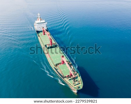 Cargo bulker vessel, bulk carrier with deck cranes sailing in sunny day, aerial view, transporting grains, crops via sea Royalty-Free Stock Photo #2279539821