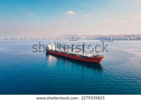 Bulk carrier or bulker anchored nearby port waiting uploading, Aerial wide shot Royalty-Free Stock Photo #2279539825