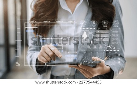 Business woman hand Project manager working and update tasks and Gantt chart scheduling virtual diagram.with tablet in office. Royalty-Free Stock Photo #2279544455