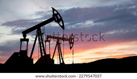 The change in oil prices caused by the war. Oil price cap concept. Oil drilling derricks at desert oilfield. Crude oil production from the ground. Petroleum production. Royalty-Free Stock Photo #2279547037