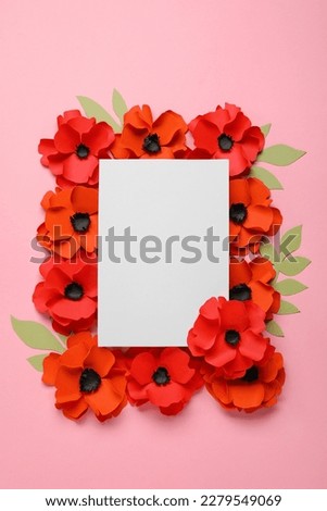 Blank paper sheet with poppy flowers and leaves on pink background